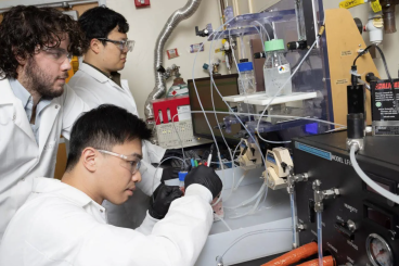 A new electrochemical reactor design developed with Marta Hatzell by postdoctoral scholar Hakhyeon Song (middle) and Ph.D. students Carlos Fernández and Po-Wei Huang (seated) converts carbon dioxide removed from the air into useful raw material. 