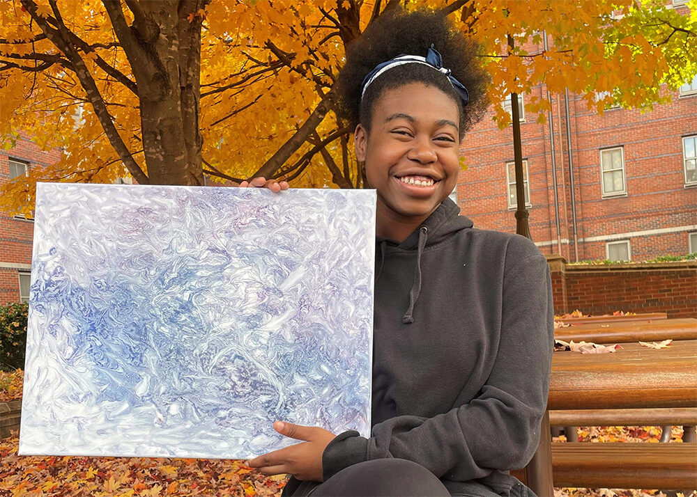 Kiara with one of her paintings